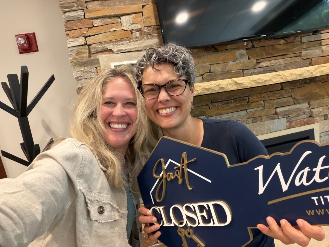 Andrea Scanlon with a client holding a Just Closed sign